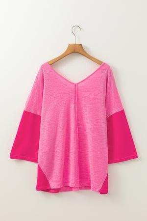 Hot pink V-neck blouse with contrast sleeves and textured front panel