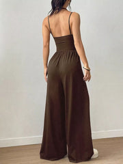 Brown ruched wide-leg jumpsuit with spaghetti straps and a cinched waist.