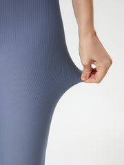 Ribbed high-waist leggings in light blue, showing stretch fabric detail.