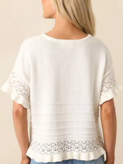 White knit top with crew neck, short sleeves, and delicate lace trim at hem and cuffs.