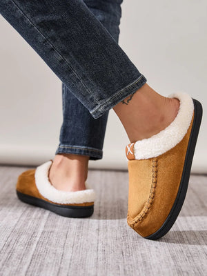 Caramel suede shearling-lined moccasin slides with contrast stitching detail.