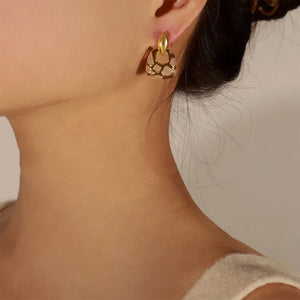 Geometric enamel drop earrings with gold accents and a cutout pattern.