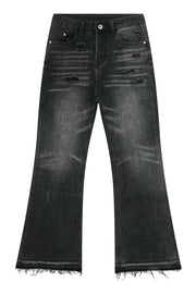 Distressed flare jeans in washed black denim with frayed hems.
