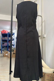 Black asymmetrical button-down midi dress with a sleeveless cut and A-line skirt.