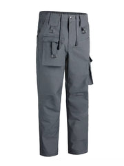 Men's grey functional cargo pants with multiple pockets and buckle details.