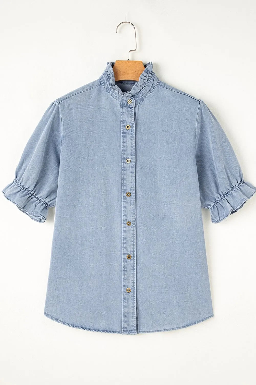 Light blue denim blouse with ruffled collar, puff sleeves, and button front.