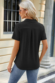Black textured polo shirt with V-neck detail and short sleeves.