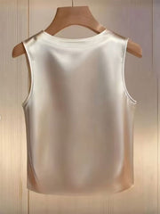 Apricot satin tank top with pearl embellishments, crew neck, sleeveless.