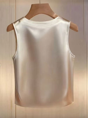 Apricot satin tank top with pearl embellishments, crew neck, sleeveless.