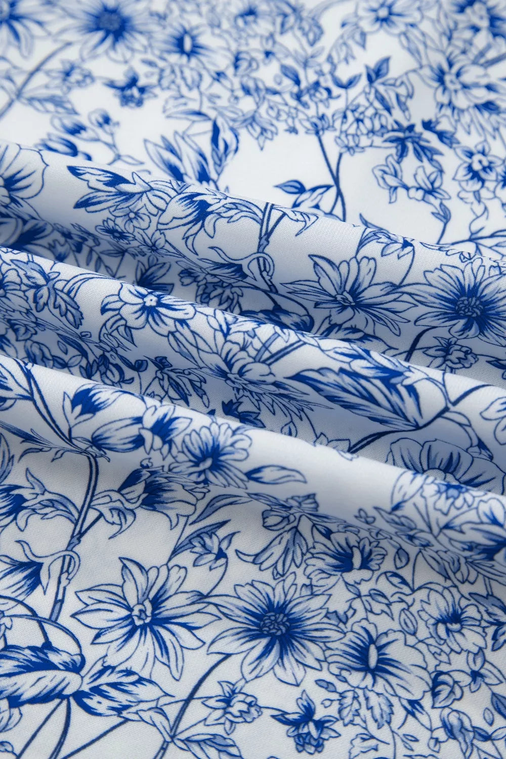 Maxi dress in white with a blue floral print and knot detail