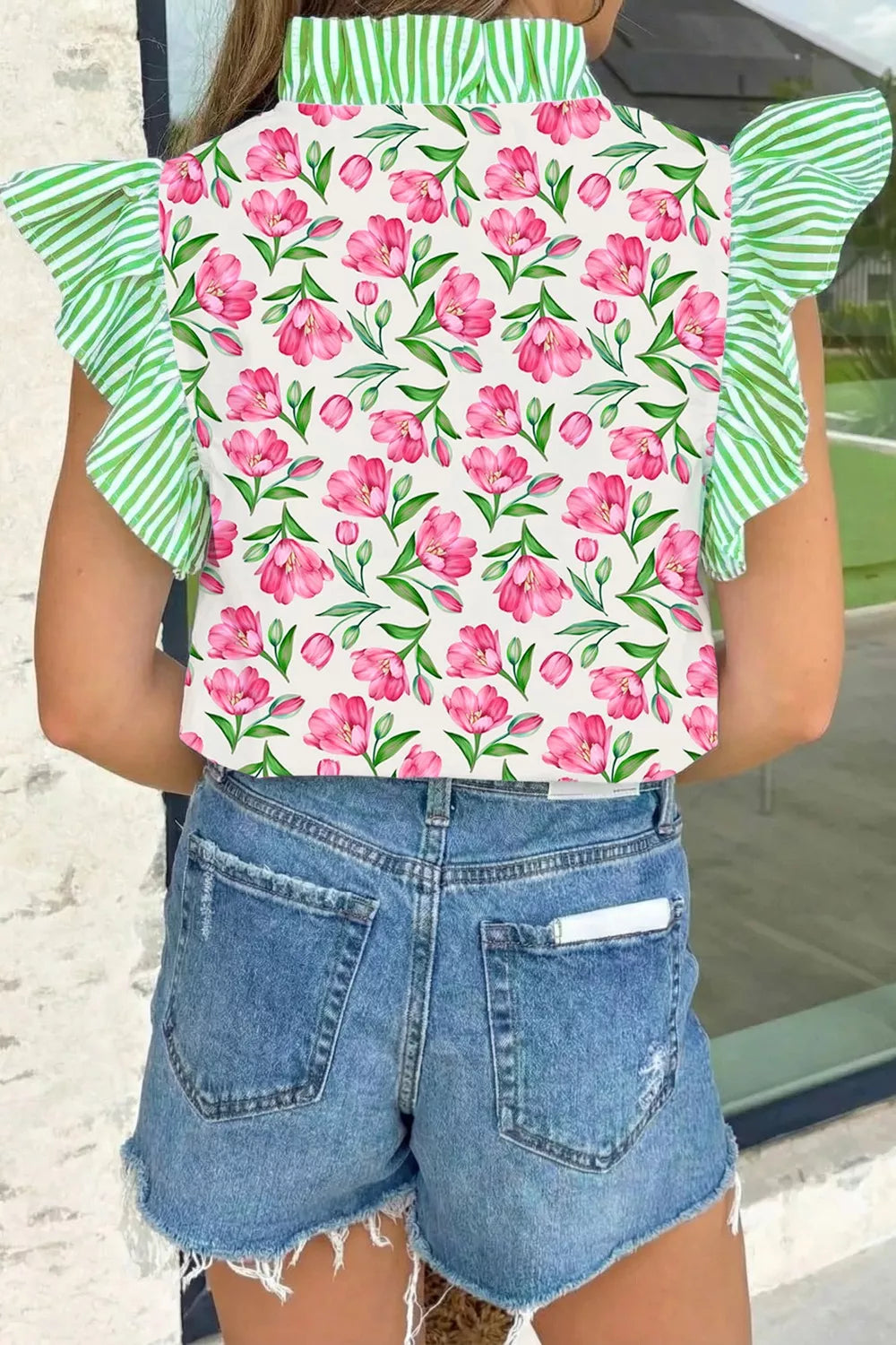 Tulip print ruffled V-neck shirt with green striped sleeves and collar.