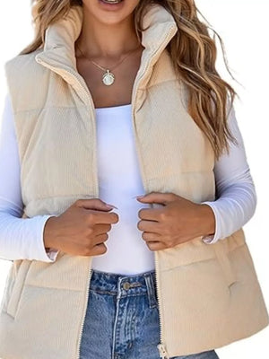 Off-white corduroy zip-up vest coat with quilted detail and high collar.
