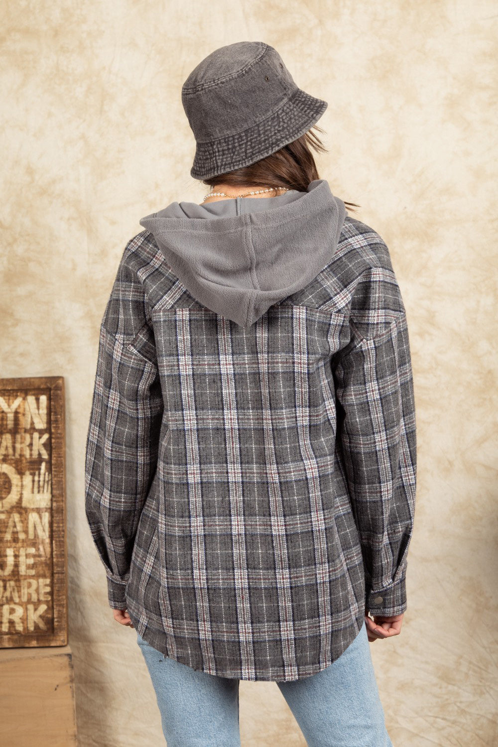 Cozy plaid shacket in Dark Gray with sherpa hood and buttoned cuffs.