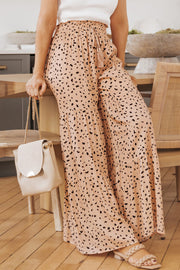 Dalmatian print palazzo trousers in watermelon pink with tiered ruffles and adjustable drawstring waist.