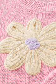 Knit sleeveless top in pink with a cream floral embroidery detail and lavender center.