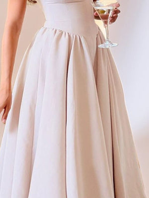 Beige A-line midi dress with a boat neck and cap sleeves, featuring a full skirt.