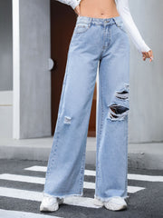 Light wash distressed wide-leg jeans with fray hem and ripped details.