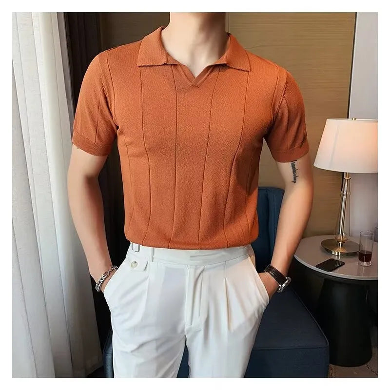 Orange textured knit polo shirt with vertical ribbing and short sleeves.