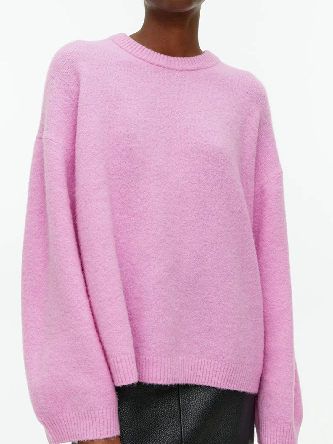 Oversized pink brushed knit crewneck sweater with ribbed cuffs and hem