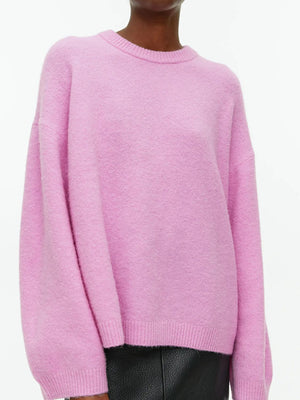 Oversized pink brushed knit crewneck sweater with ribbed cuffs and hem