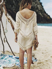 White crochet V-neck cover-up with chevron pattern and fringe details.