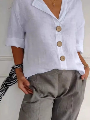 White linen button-down shirt with relaxed fit and wooden buttons.