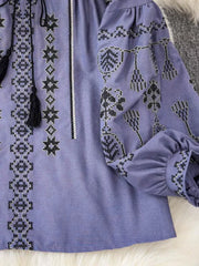 Purple embroidered tie neck blouse with tassels and puff sleeves.