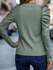 Sage knit top with ruched sleeves and gold button detail on cuffs.