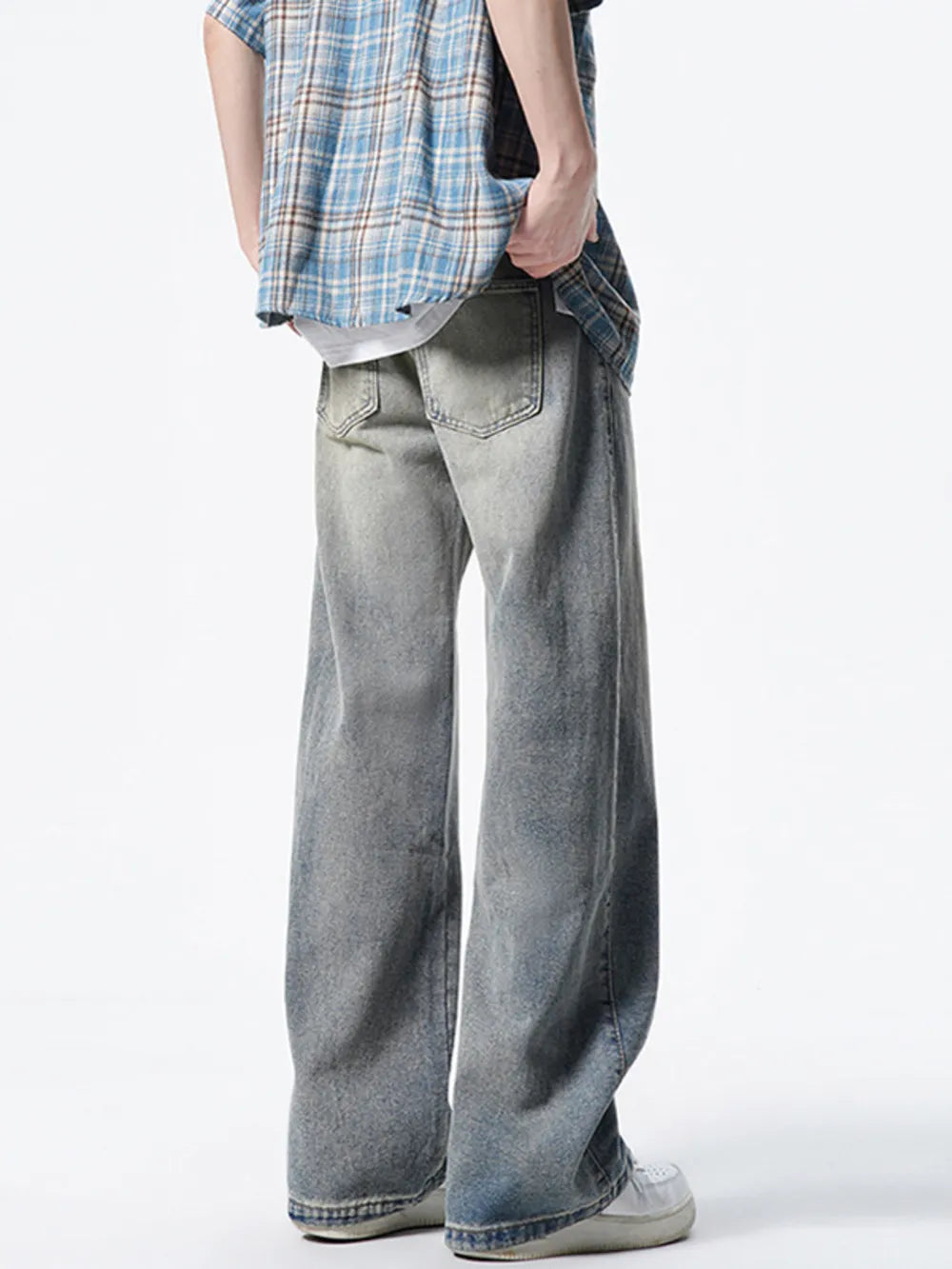 Men's distressed wide leg jeans in vintage wash denim, ankle length.