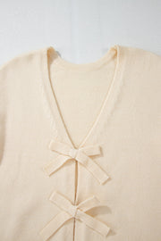 Ivory bouclé knit cardigan with tie-front bow details