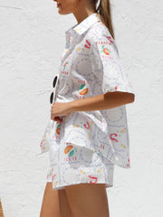 White resort set with citrus and tutti frutti print, button-up shirt and shorts.