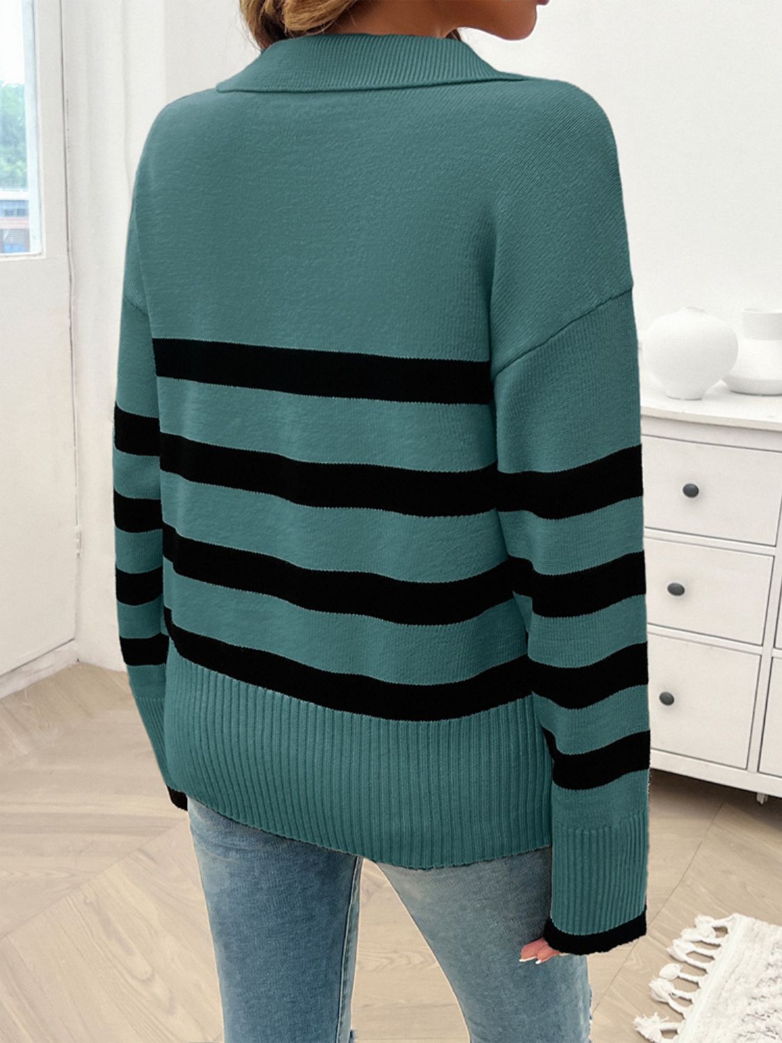 Turquoise knit sweater with bold black stripes and a collar.