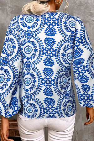 Royal blue botanical medallion print blouse with voluminous sleeves, 100% polyester.
