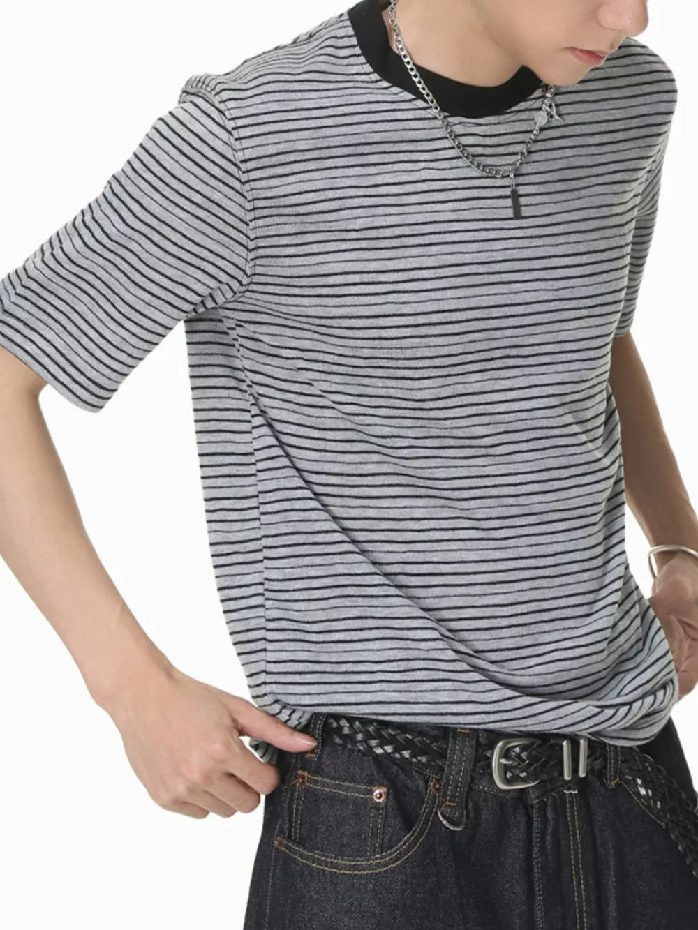 Grey striped crew neck t-shirt with black trim, short sleeves, and cotton fabric.