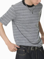 Grey striped crew neck t-shirt with black trim, short sleeves, and cotton fabric.