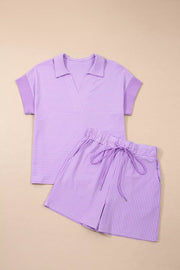 Purple striped polo shirt and drawstring shorts loungewear set.