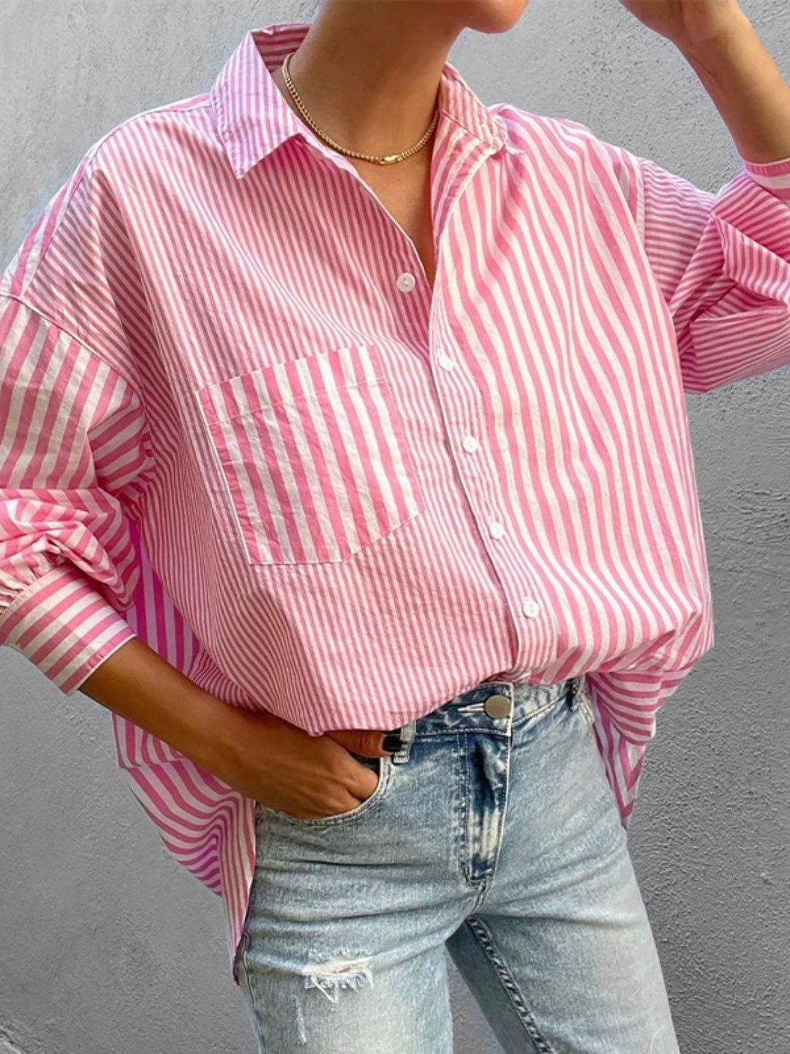 Pink and white striped oversized button-down shirt with a pocket and collar.