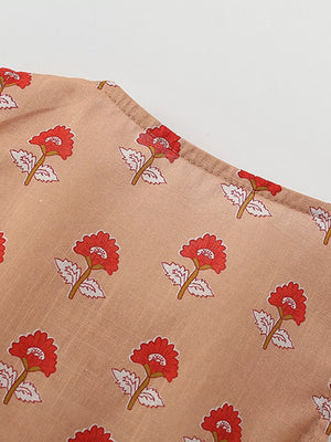 Toddler floral ruffle dress in tan cotton with red floral print.