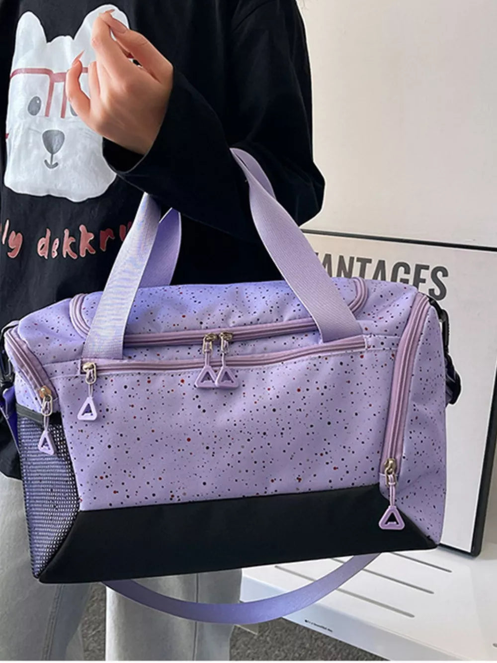 Chic speckled lavender travel bag with black contrast base and mesh side pocket.