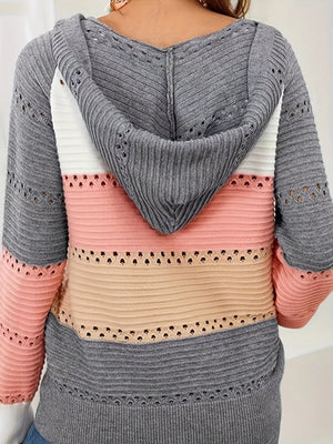 Colorblock knit hoodie with lace-up detail and cutouts in gray, white, pink, and beige.