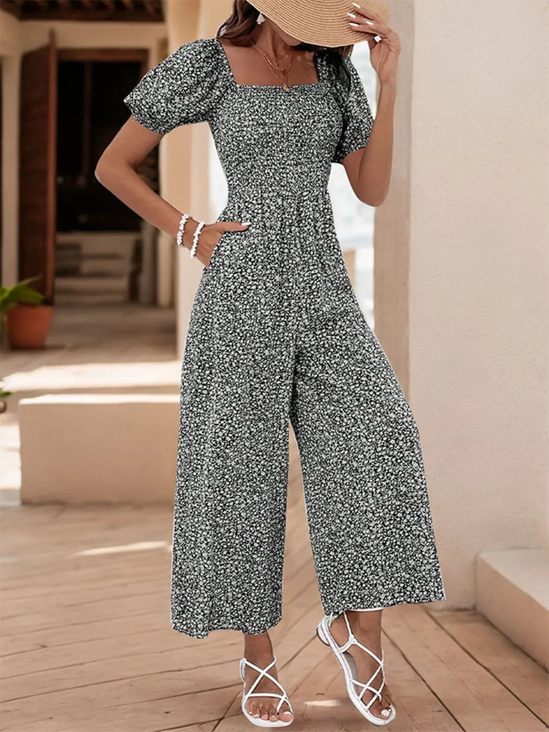 Smocked bodice floral jumpsuit with puff sleeves and wide legs in Black White.