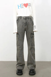 Faded dark gray denim flare cargo pants with multiple pockets and a relaxed fit.