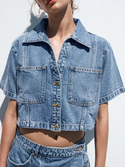 Dark blue cotton cropped button-up top with chest pockets and contrast stitching.