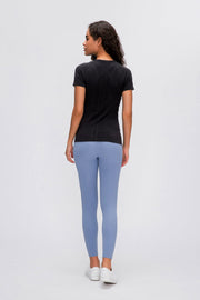 Black seamless active tee with short sleeves and subtle textured detail on back.