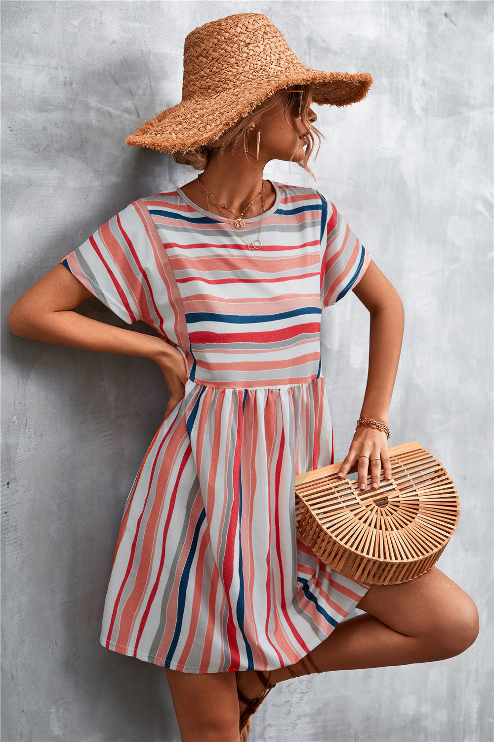 Striped trapeze dress with yoke seam in coral, navy, and grey stripes.