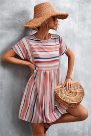 Striped trapeze dress with yoke seam in coral, navy, and grey stripes.