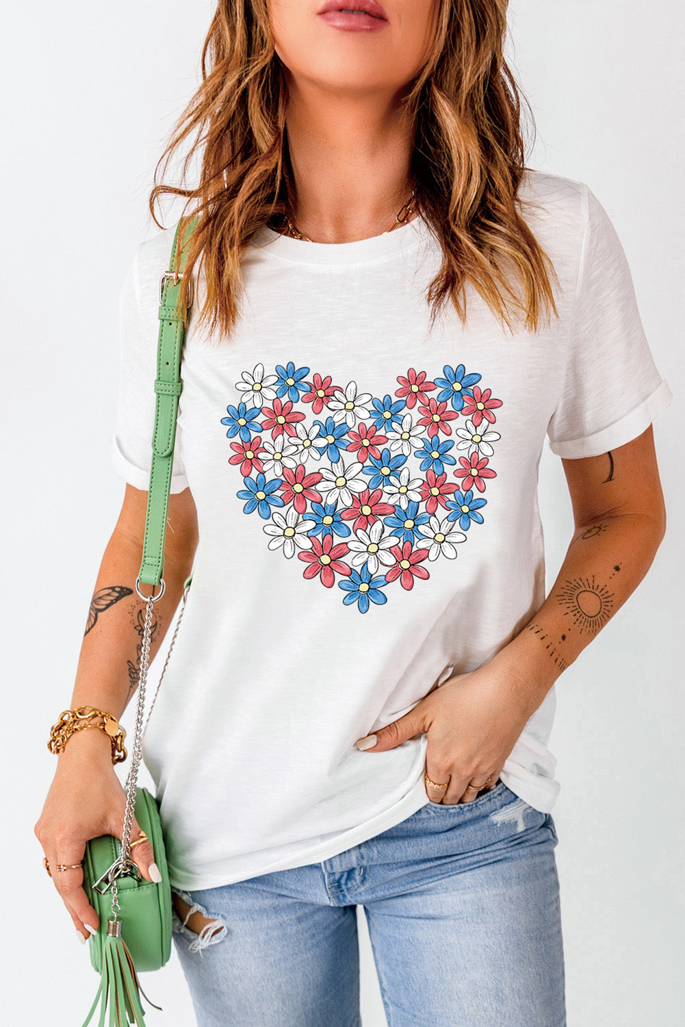 White t-shirt with a heart graphic made of red, white, and blue flowers.