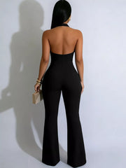 Black halter cut-out jumpsuit with button detail and flared legs.