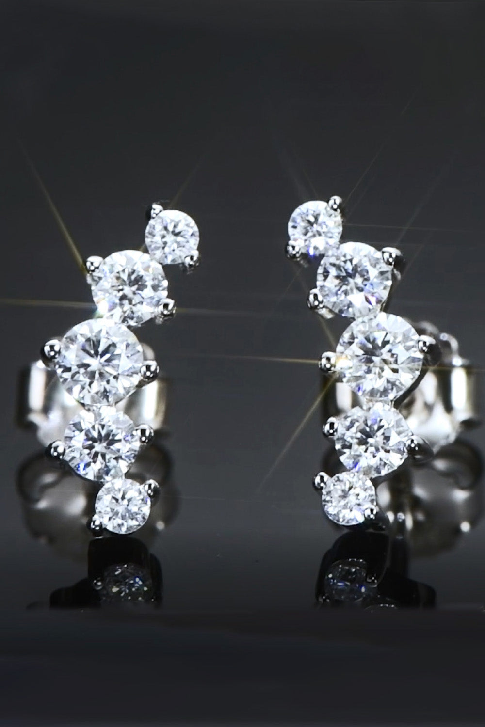 Silver stud earrings with a cascading cluster of round cubic zirconia stones.