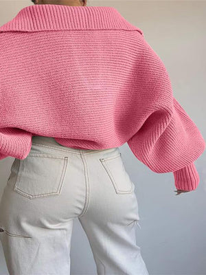 Pink knit sweater with wide collar and balloon sleeves, paired with light wash jeans.